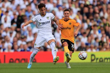 Rodrigo Moreno #19 of Leeds United passes the ball under pressure from Daniel Podence #10 of Wolverhampton Wanderers