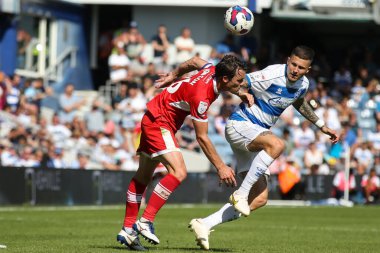 Jonathan Howson #16 of Middlesbrough and Lyndon Dykes #9 of QPR challenge for a header