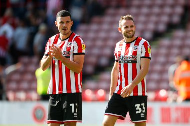 John Egan #12 of Sheffield United and Rhys Norrington-Davies #33 of Sheffield United applaud fans after the game