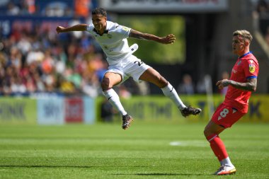 Kyle Naughton (26) of Swansea City takes a shot at goal watched on by Sammie Szmodics (8) of Blackburn Rovers  