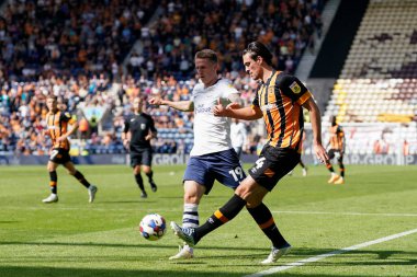 Jacob Greaves #4 of Hull City crosses the ball under pressure from Emil Riis Jakobsen #19 of Preston North End 