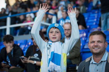 A young Huddersfield Town supporter cheers on his team during the game 