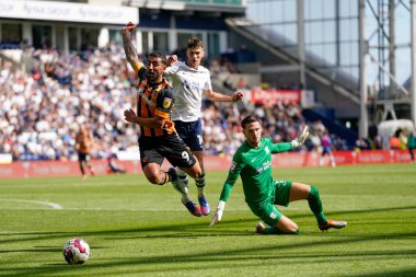 Allahyar Sayyadmanesh #9 of Hull City beats Freddie Woodman #1 of Preston North End to the ball but loses his balance and the referee waves away penalty claims