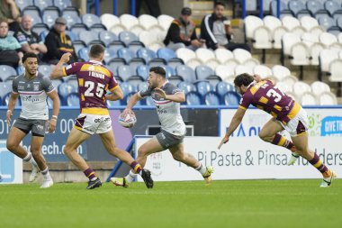 Jake Connor #1 of Hull FC looks to offload the ball to Darnell McIntosh 