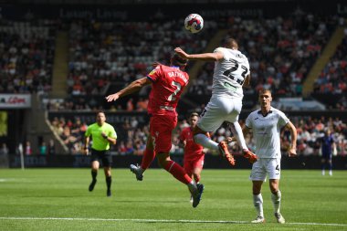 Nathan Wood (23) of Swansea City and Callum Brittain (2) of Blackburn Rovers  challenge for the high ball