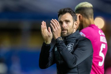 Danny Schofield manager of Huddersfield Town claps his hands and applauds the travelling supporters at full-time after losing 2-1 to Birmingham City 