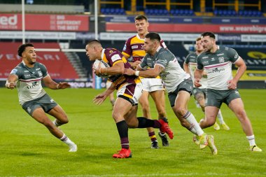 Will Smith #40 of Hull FC tackles Tui Lolohea #6 of Huddersfield Giants 