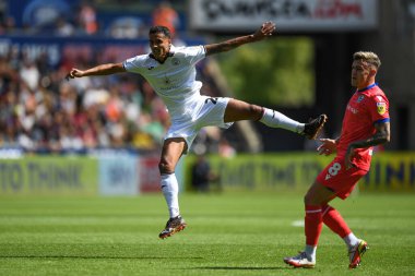 Kyle Naughton (26) of Swansea City takes a shot at goal watched on by Sammie Szmodics (8) of Blackburn Rovers  