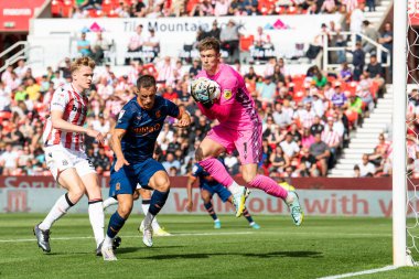 Josef Bursik #1 of Stoke City beats Jerry Yates #9 of Blackpool to the ball