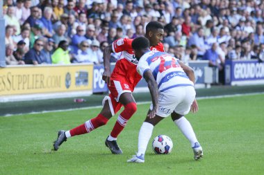 Isaiah Jones #2 of Middlesbrough runs at Kenneth Paal #22 of QPR 