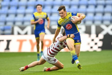 Josh Thewlis #22 of Warrington Wolves is tackled by Jai Field #23 of Wigan Warriors