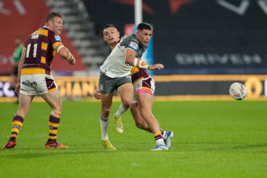 Will Smith #40 of Hull FC  chips the ball past Danny Levi #9 of Huddersfield Giants