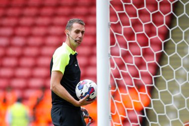 Referee David Coote checks the goal line technology before the game