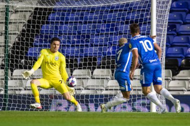 Juninho Bacuna #7 of Birmingham City takes a shot at Lee Nicholls #21 of Huddersfield Town during the second half 