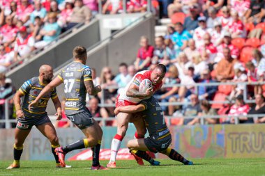 Curtis Sironen #16 of St Helens is held by Danny Richardson #7 of Castleford Tigers