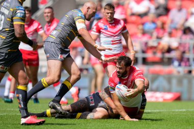 Alex Walmsley #8 of St Helens offloads the ball