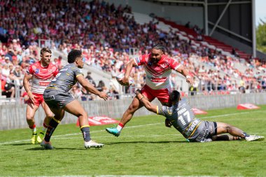 Konrad Hurrell #23 of St Helens looks to offload the ball to Tommy Makinson