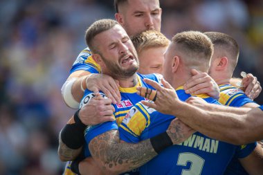 Zak Hardaker #33 of Leeds Rhinos celebrates with his team mates as Harry Newman scores the opening try of the game 