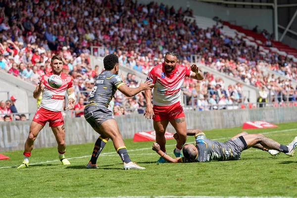 Konrad Hurrell #23 of St Helens looks to offload the ball to Tommy Makinson