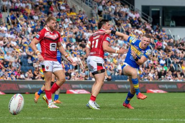 Harry Newman #3 of Leeds Rhinos kicks the ball forward during the attack