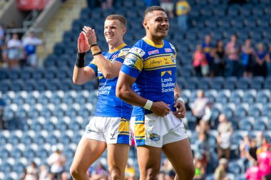 Ash Handley #5 of Leeds Rhinos and David Fusitua #2 of Leeds Rhinos celebrate with the supporters after beating Salford 