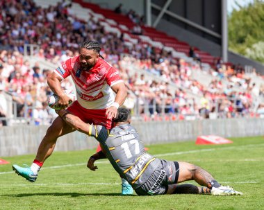 Konrad Hurrell #23 of St Helens looks to off load in the tackle from Mahe Fonua #17 of Castleford Tigers