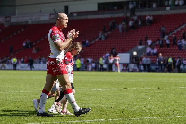 James Roby #9 of St Helens salutes the fans after the game with his children