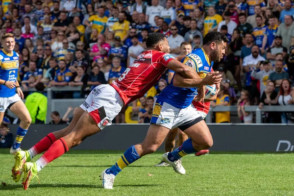 Rhyse Martin #12 of Leeds Rhinos gets the better of Kallum Watkins #3 of Salford Red Devils and goes over for a try making it 32-14