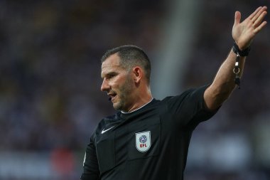 Referee Tim Robinson gives a corner kick