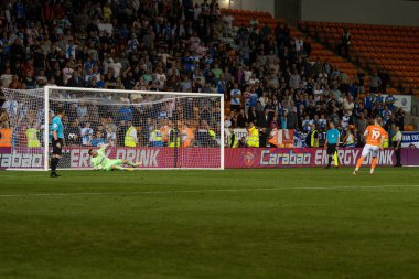 Shayne Lavery #19 of Blackpool scores his penalty after re taking it