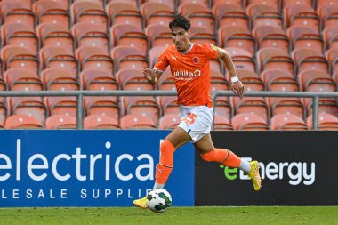 Theo Corbeanu #25 of Blackpool makes a break with the ball