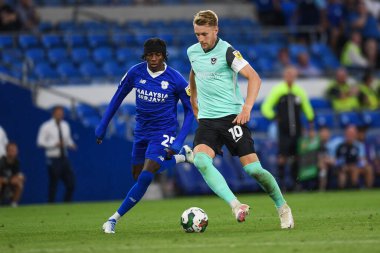 Joe Pigott #10 of Portsmouth  Under pressure from Jaden Philogene-Bidace #25 of Cardiff City  