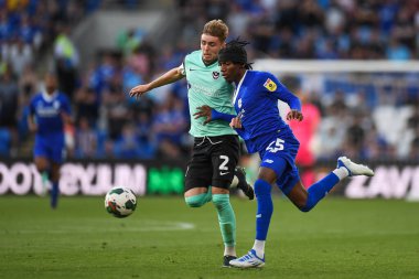 Zak Swanson #2 of Portsmouth,  under pressure from Jaden Philogene-Bidace #25 of Cardiff City  