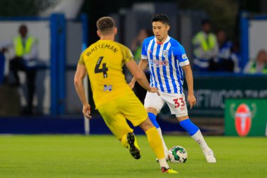 Yuta Nakayama #33 of Huddersfield Town is confronted by Ben Whiteman #4 of Preston North End