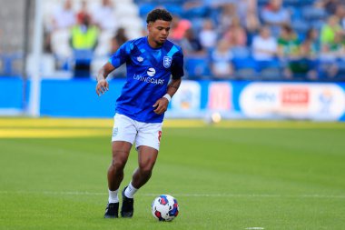 Tino Anjorin #8 of Huddersfield Town warms up for the game