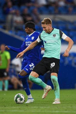 Joe Pigott #10 of Portsmouth  Under pressure from Jaden Philogene-Bidace #25 of Cardiff City  