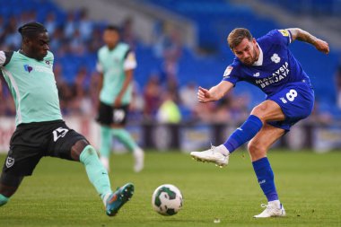 Joe Ralls #8 of Cardiff City  shoots under pressure from Jay Mingi #25 of Portsmouth  