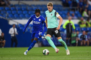Joe Pigott #10 of Portsmouth  Under pressure from Jaden Philogene-Bidace #25 of Cardiff City  