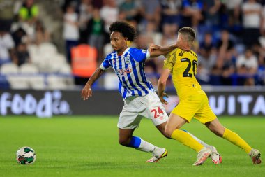 Etienne Camara #24 of Huddersfield Town tries to shrug off Ben Woodburn #20 of Preston North End