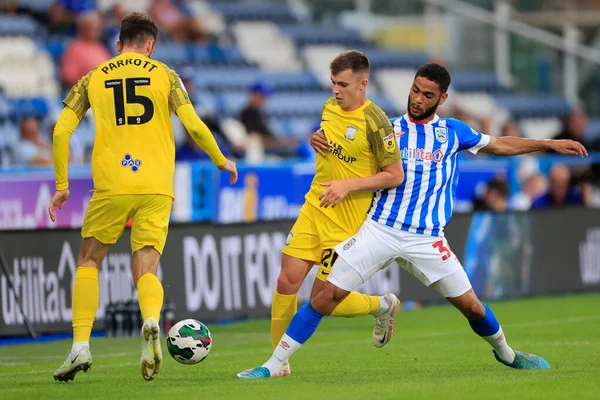 Brodie Spencer #34 of Huddersfield Town  challenges Ben Woodburn #20 of Preston North End