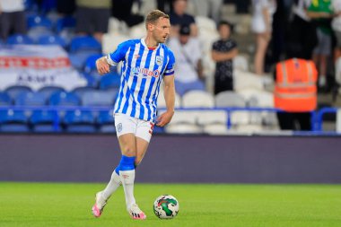 Tom Lees #32 of Huddersfield Town controls the ball