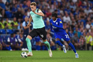 Joe Pigott #10 of Portsmouth  Under pressure from Jaden Philogene-Bidace #25 of Cardiff City  
