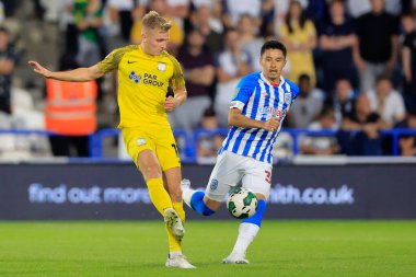 Yuta Nakayama #33 of Huddersfield Town keeps a close watch on Ali McCann #13 of Preston North End