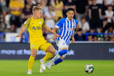 Yuta Nakayama #33 of Huddersfield Town keeps a close watch on Ali McCann #13 of Preston North End