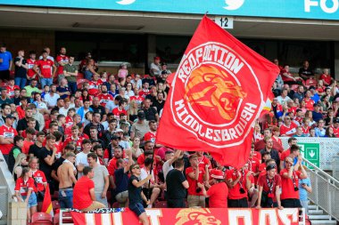The Middlesbrough supporters cheer on their team during the game 