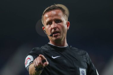 Referee David Webb gives a talking to a ball boy