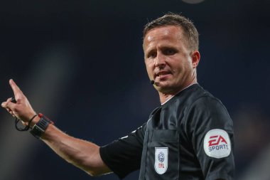 Referee David Webb gives a talking to a ball boy