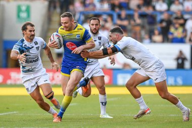 Ben Currie #11 of Warrington Wolves breaks the tackle of Tony Gigot #31 of Toulouse Olympique