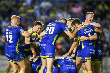 George Williams #7 of Warrington Wolves celebrates his try with team mates