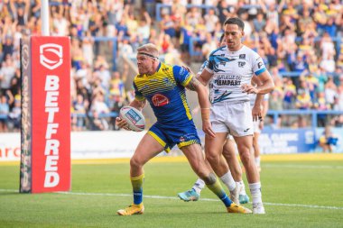 Oliver Holmes #12 of Warrington Wolves celebrates his try